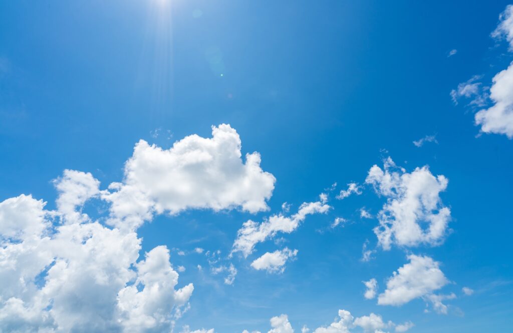 Blue sky and white clouds with sunlight on sunny day. World ozone day concept. Blue sky background
